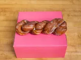 A cinnamon twist on a pink box.