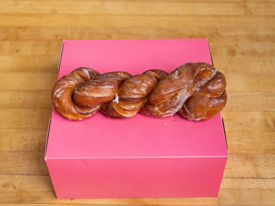 A cinnamon twist on a pink box.