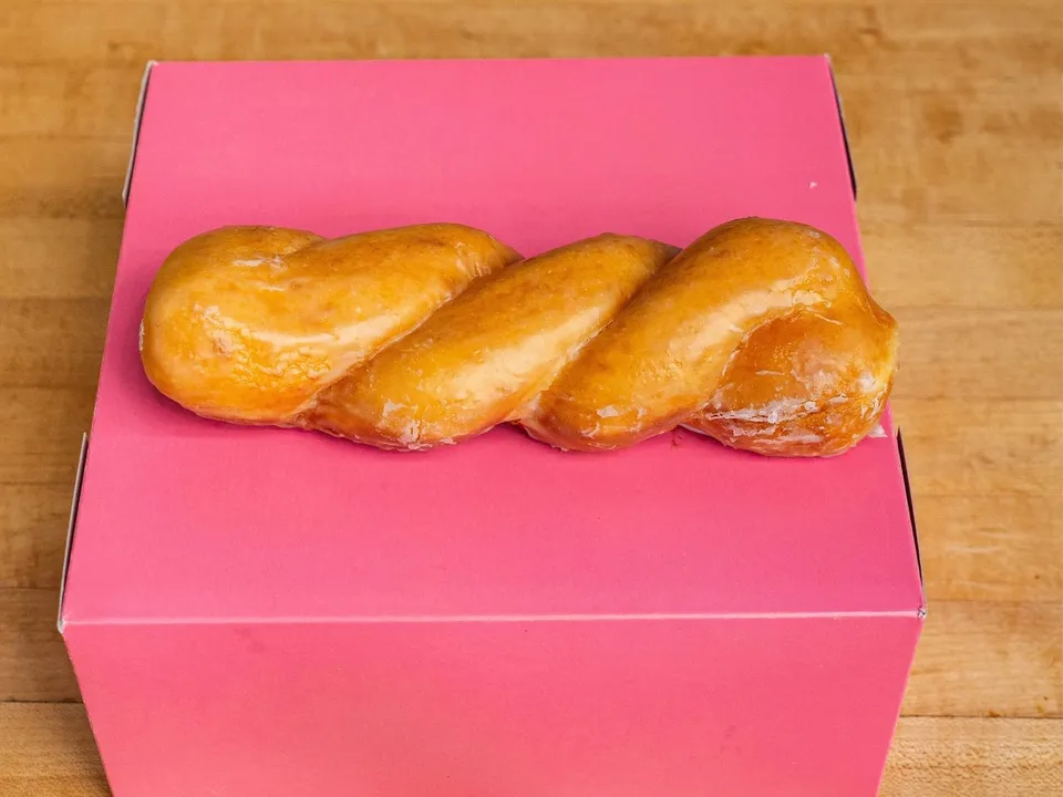 A glazed twist on a pink box.