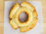 A plain old fashioned donut on white paper.